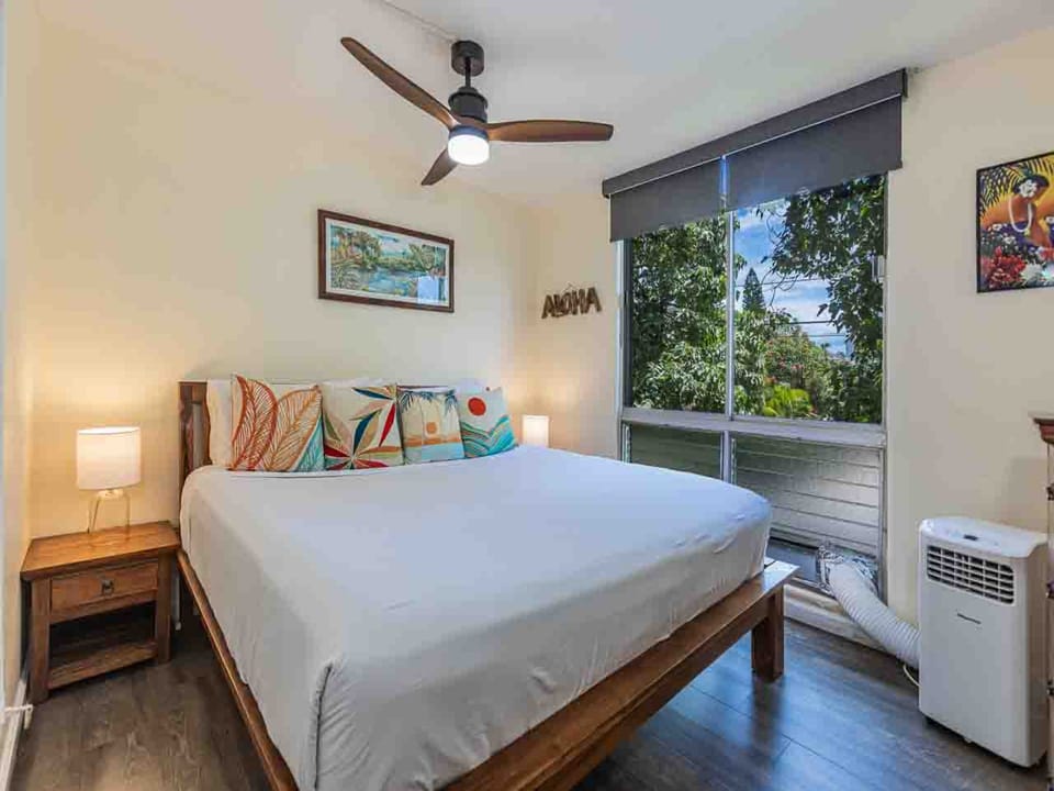 Unwind in your comfortable bedroom with tropical garden views and a ceiling fan and AC to keep you cool.