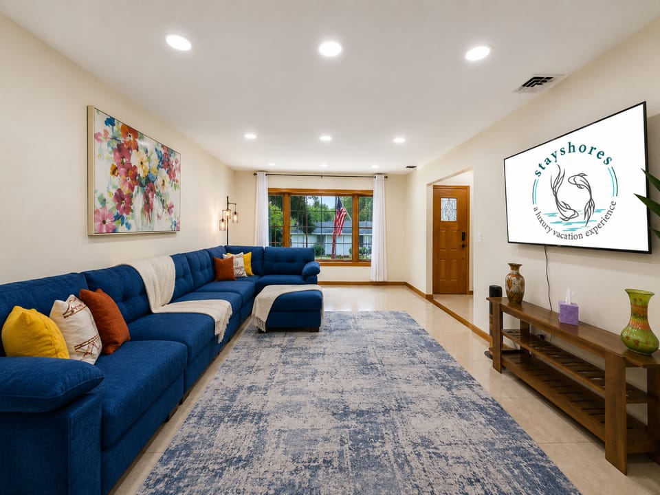 Bright living room with oversized sectional, big TV, and inviting open layout