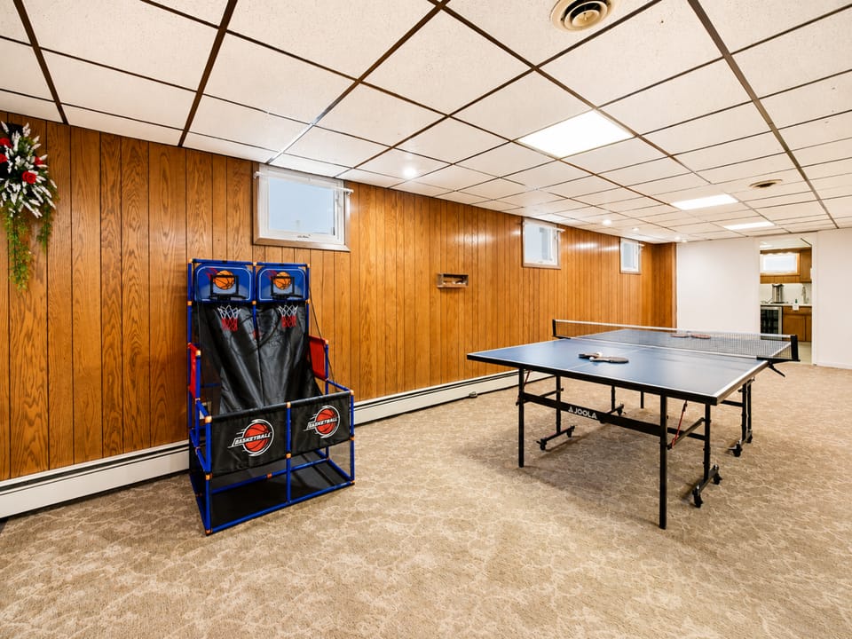 Spacious game room with ping pong and arcade basketball fun