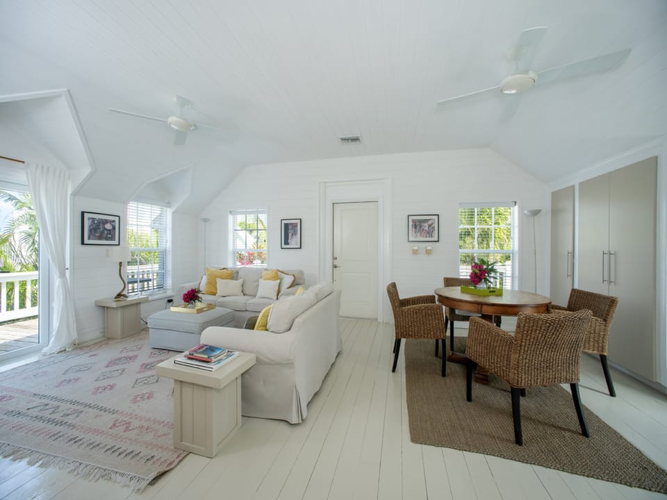 Open-plan living and dining area with French doors to the wrap-around veranda.