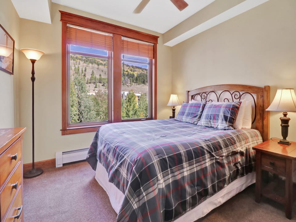 Wake up to forested mountainsides framed by your bedroom windows. Warm wood tones and soft lighting create a cozy alpine retreat for your restful nights.
