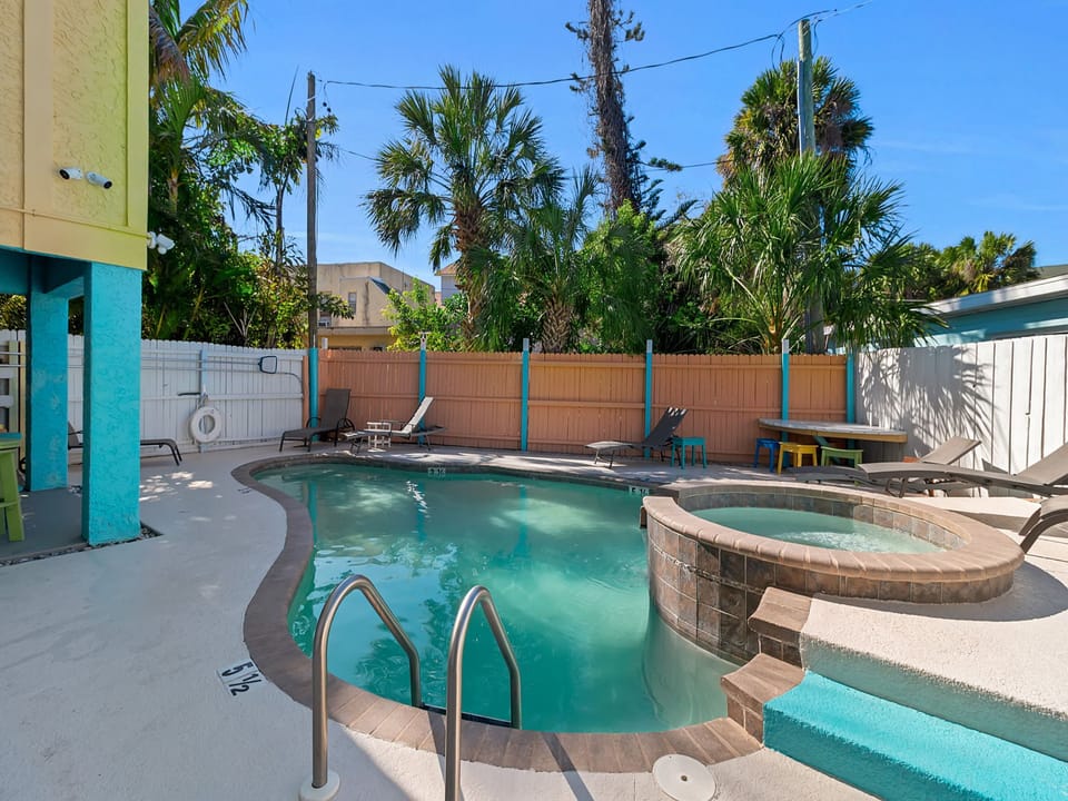 Your private oasis awaits with a refreshing pool and spa surrounded by tropical palms. Soak up the sun on the lounge chairs or unwind in the hot tub after a day of exploring.