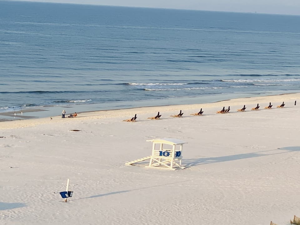 Gorgeous sandy white beach in front of Gulf Tower with a lifeguard tower.