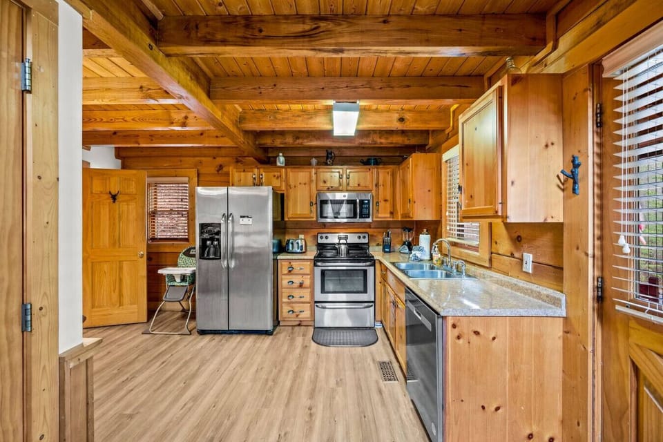 Fully stocked kitchen with a suite of stainless steel appliances.