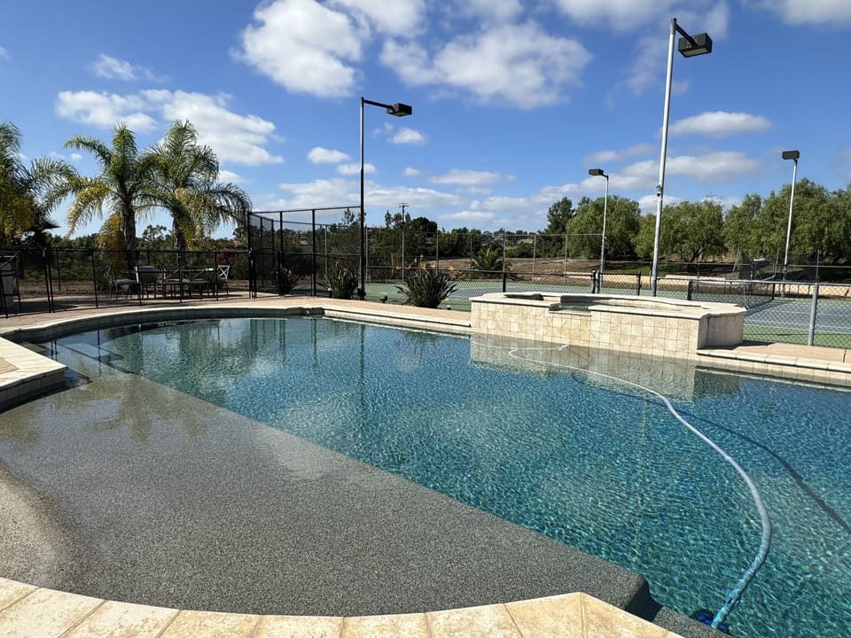 Pool has beach entry with a child safety gate that can be partially removed