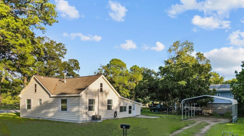 Back entrance into garage/work area. Carport for covered parking. 