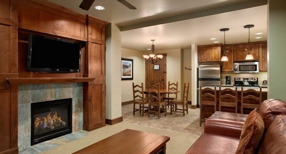 Kitchen, dining area and living room with fireplace and TV
