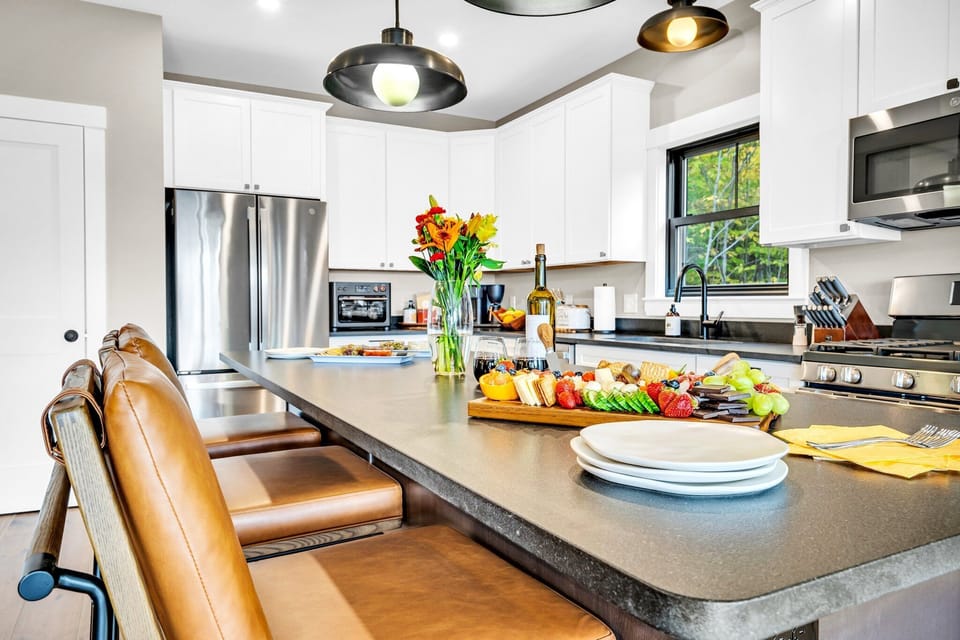 The kitchen island offers a haven for a quick bite or an enjoyable appetizer!