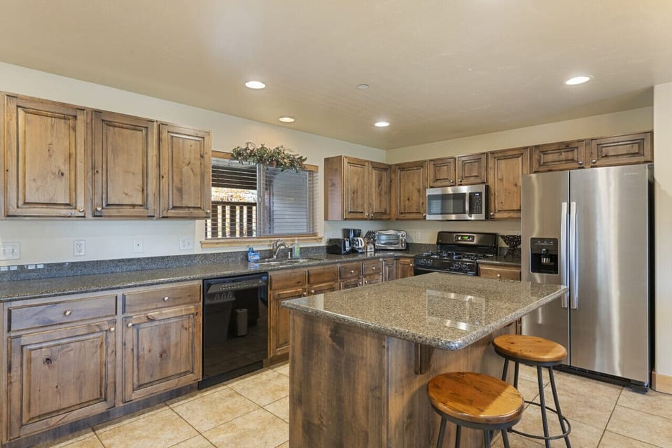 Seating for Two at Kitchen Breakfast Bar - Door Leads to Covered Deck with Large Hot Tub
