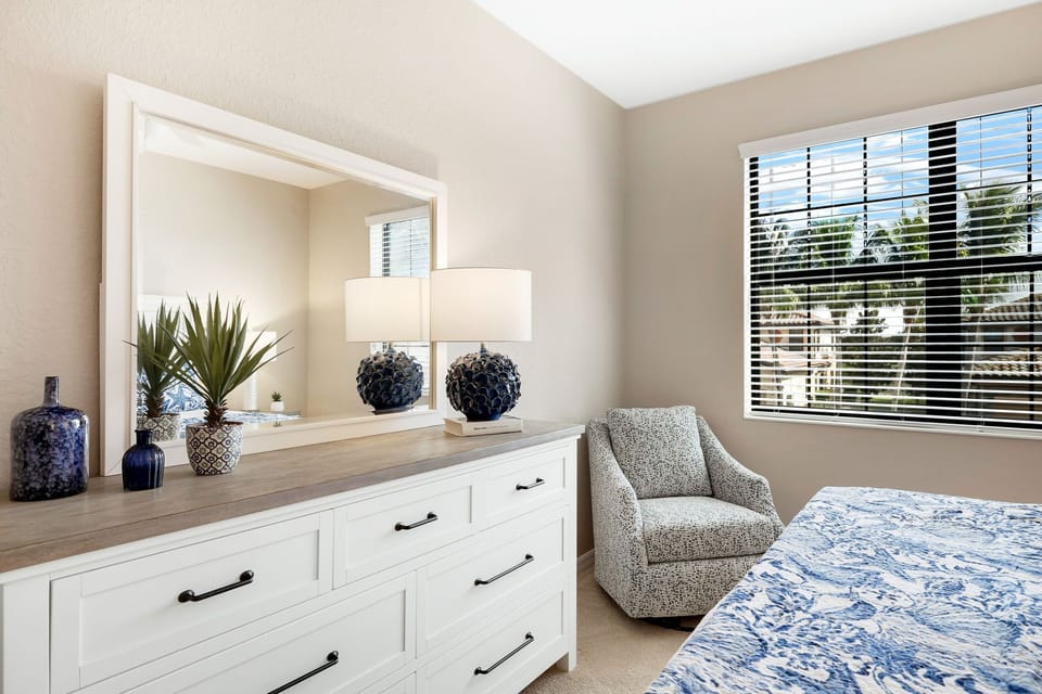 Second Bedroom has Large Dresser and Comfortable Chair