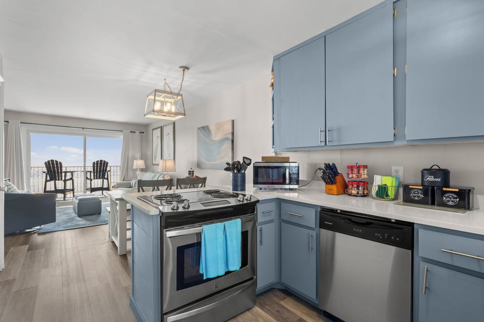 Coastal kitchen-living with balcony and ocean view—bright and modern