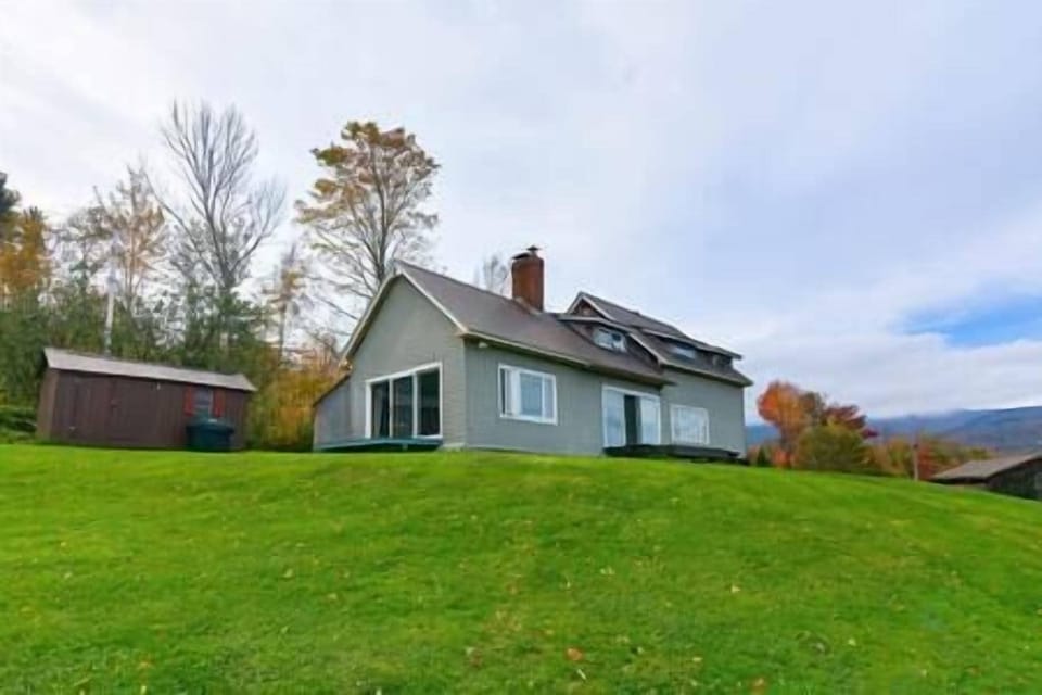 House is at the top of a hill, overlooking the Green Mountains