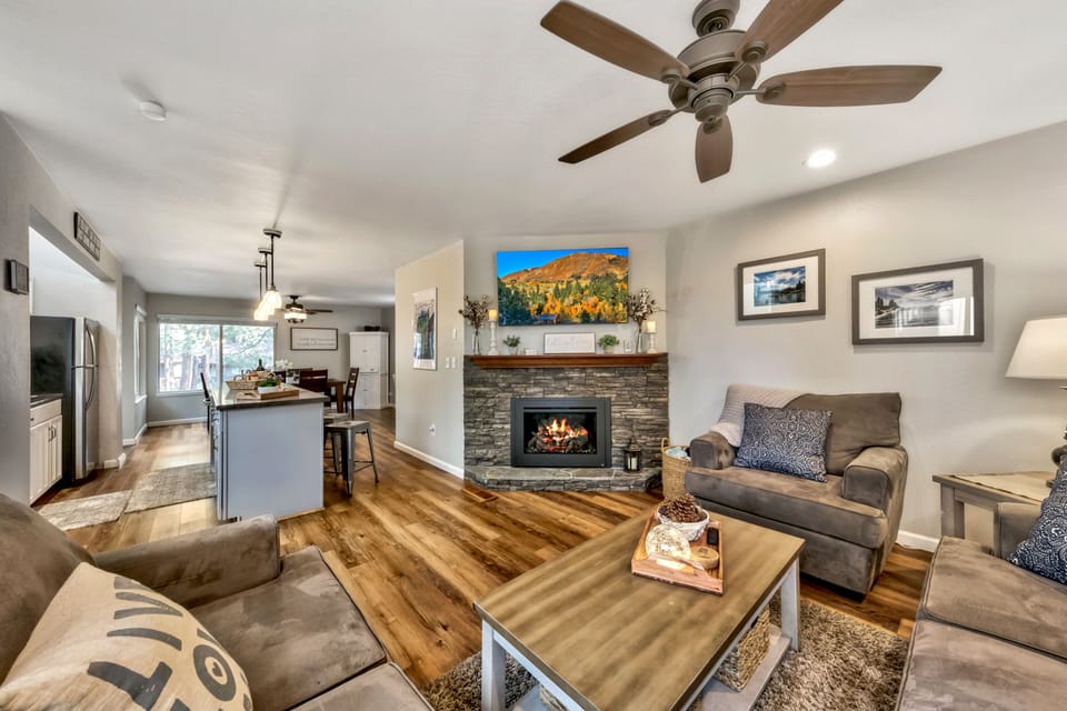 Living room area, fireplace, ceiling fan, sofa, loveseat, chair, table 