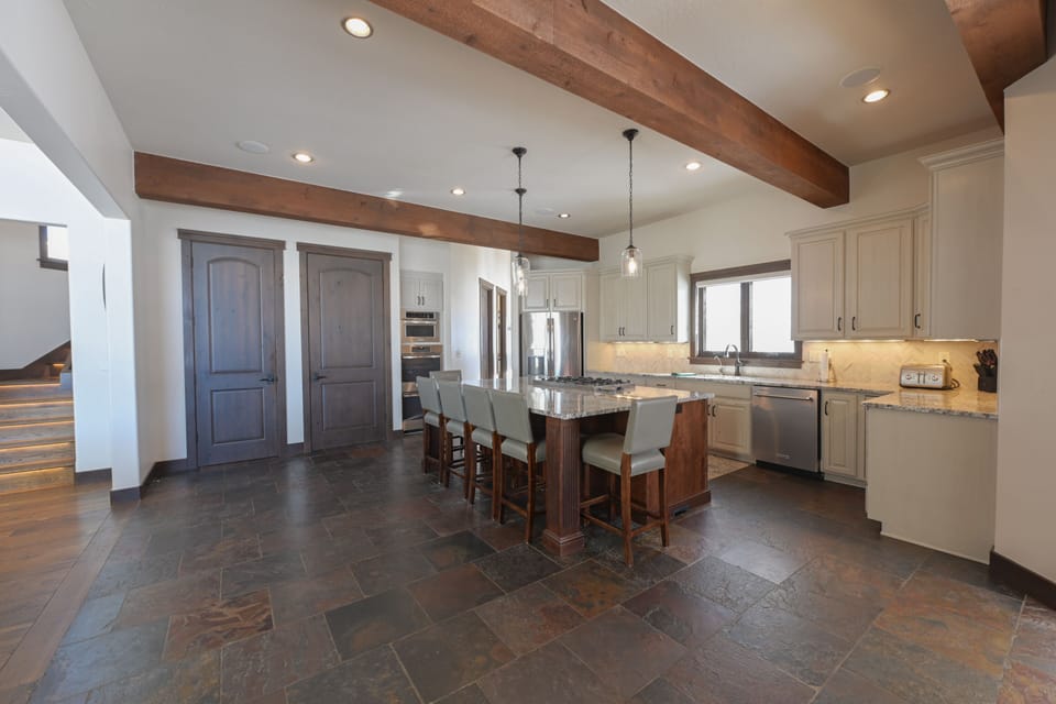 The expansive kitchen with 2 ovens, and large eat-in kitchen island