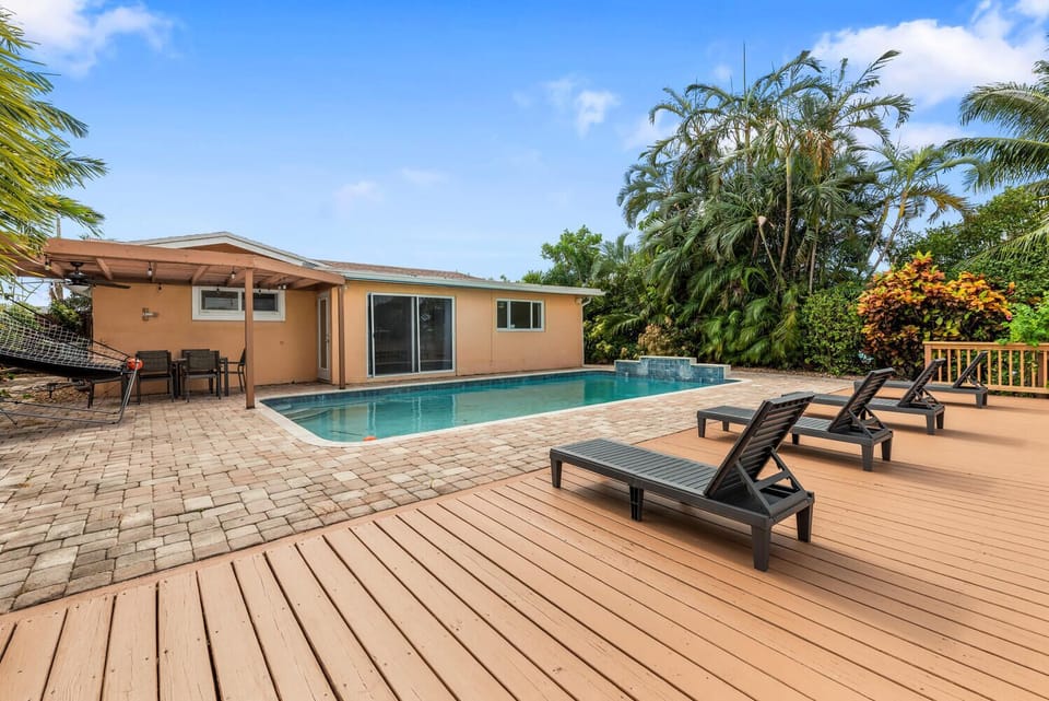 Pool with beautiful decking and an array of sun loungers