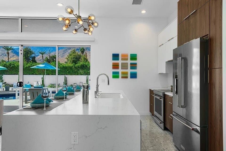 Step into a chef's paradise with this stylish, well-appointed modern kitchen. Featuring stainless steel appliances, sleek countertops, & ample cabinet space, it's the perfect space to cook & gather with family & friends, creating delicious memories!
