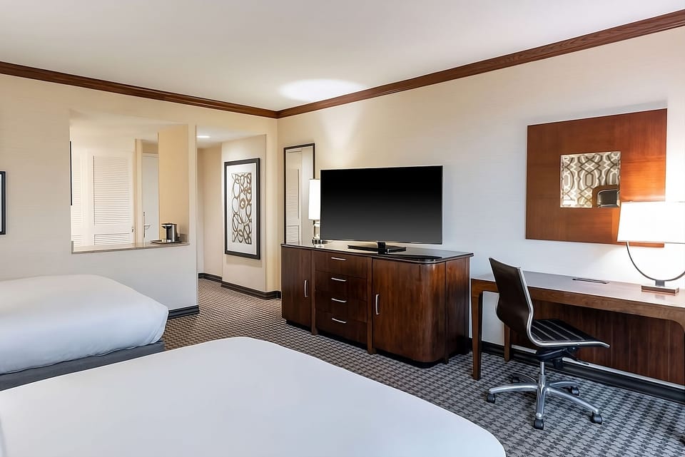 Refresh in a roomy double-queen layout with dedicated workspace.