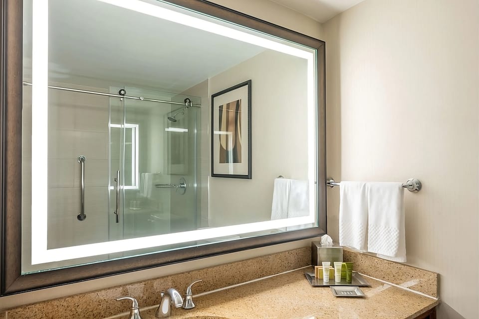 Refresh at a bright vanity with fresh towels and toiletries ready.