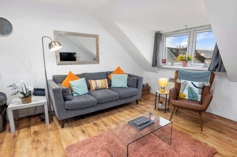 Living area with ample natural lighting and comfortable seating