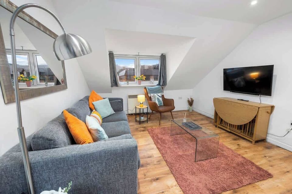 Living area with ample natural lighting and comfortable seating
