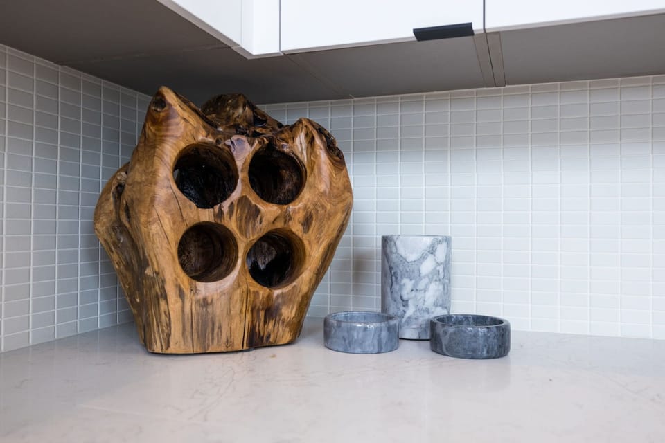 Main Level: Fully equipped kitchen with stainless-steel appliances and essential supplies, complemented by a bar seating for 4, seamlessly connecting to the spacious dining area for a perfect blend of functionality and style.