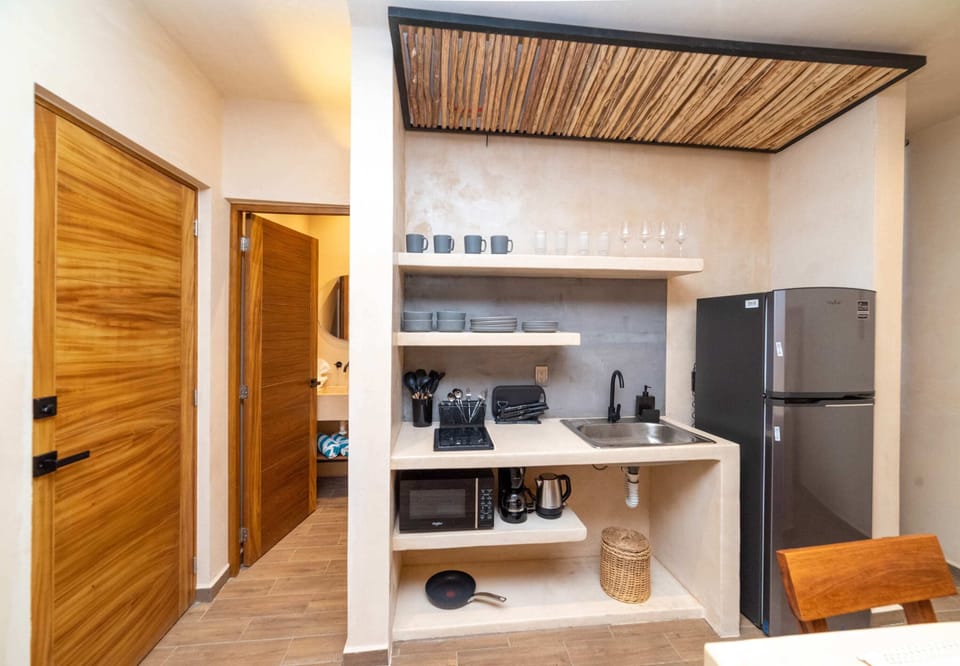 a bedroom with bed and table in Tulum apartment rentals