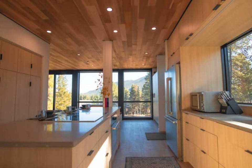 The kitchen, dining & living room have an amazing view from a 40ft glass wall