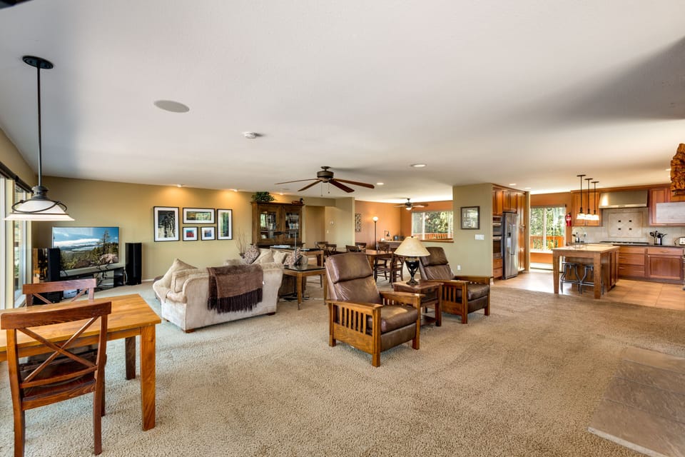 Spacious open-concept living area with cozy seating, warm decor, and plenty of natural light