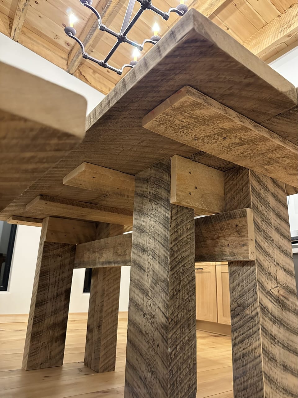 the custom site built dining room table from the left over beams