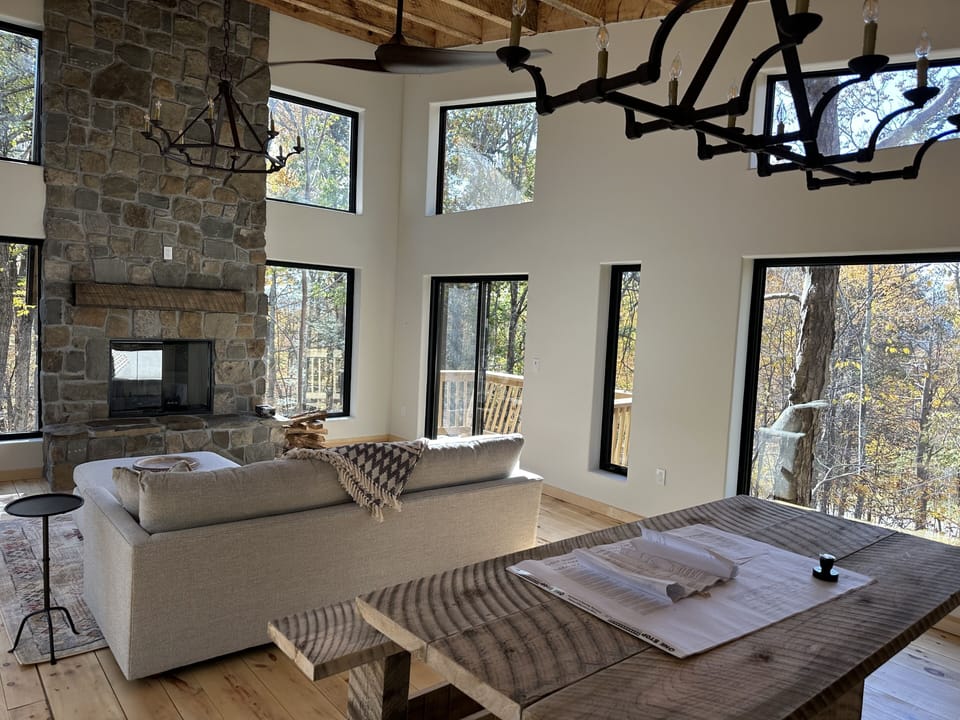 great room with site built dining table from the left over rough cut beams 