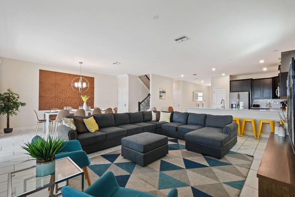 Spacious open-concept living area with modern kitchen, dining, and cozy seating.