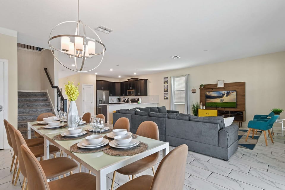Modern open-concept space with elegant dining, cozy seating, and full kitchen.
