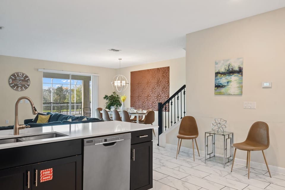 Sleek kitchen with open flow to dining, lounge, and relaxing poolside views.
