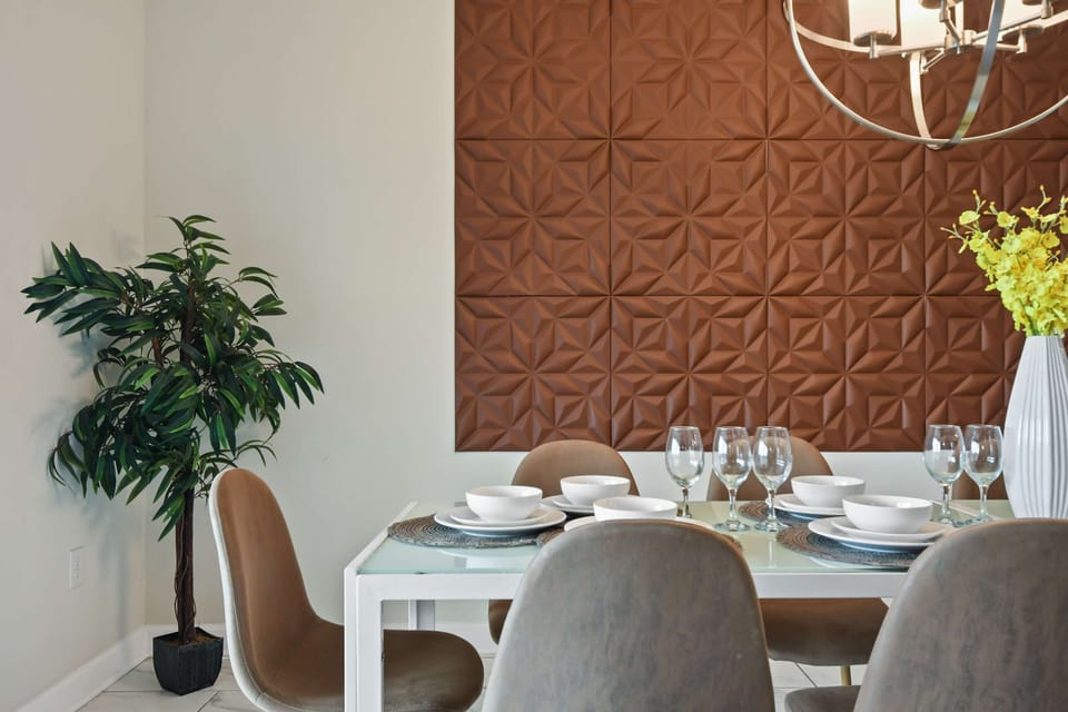 Stylish dining area with unique accent wall and elegant table setting for eight.