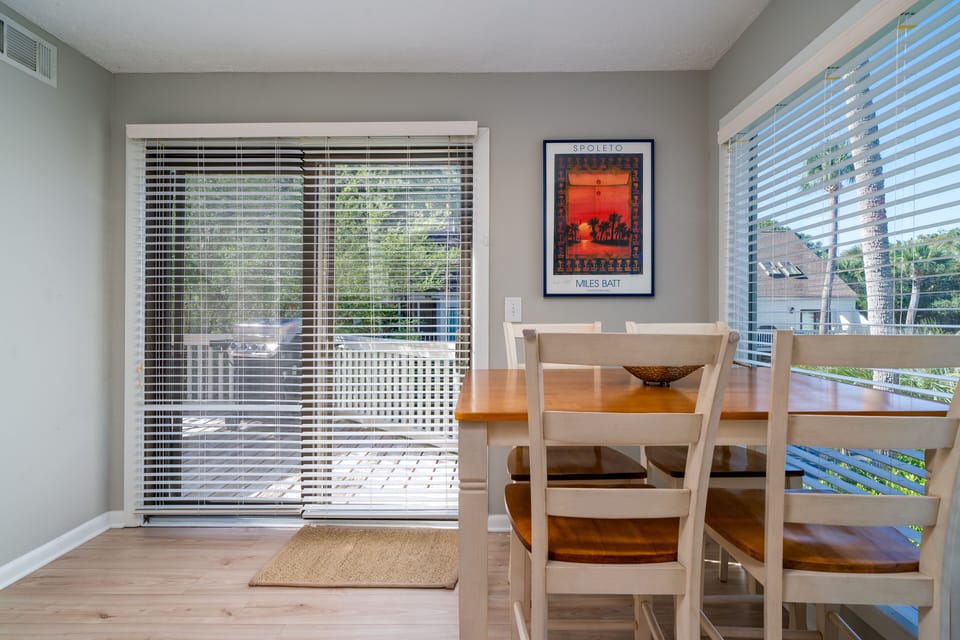 The breakfast table in the kitchen. Doors lead out to the deck area