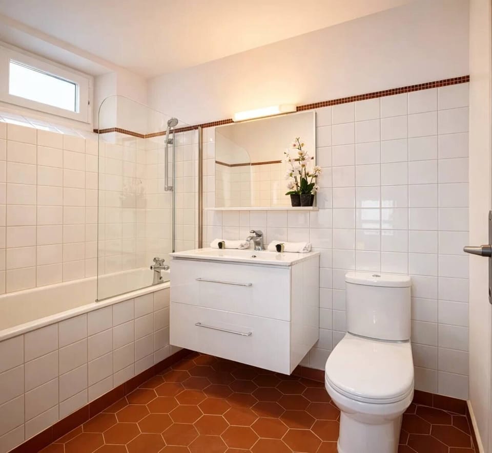 A bathroom well equipped with bath-shower, toilets and brand new sink