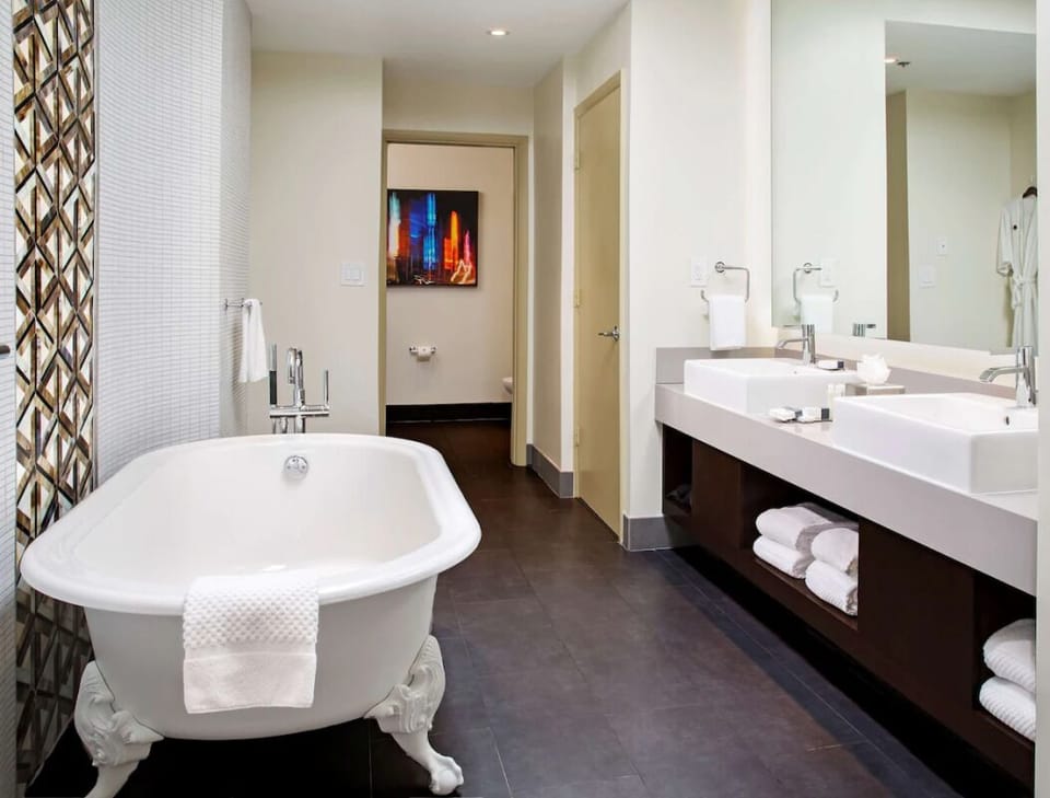 Unwind in a deep soaking tub beside double vanity.
