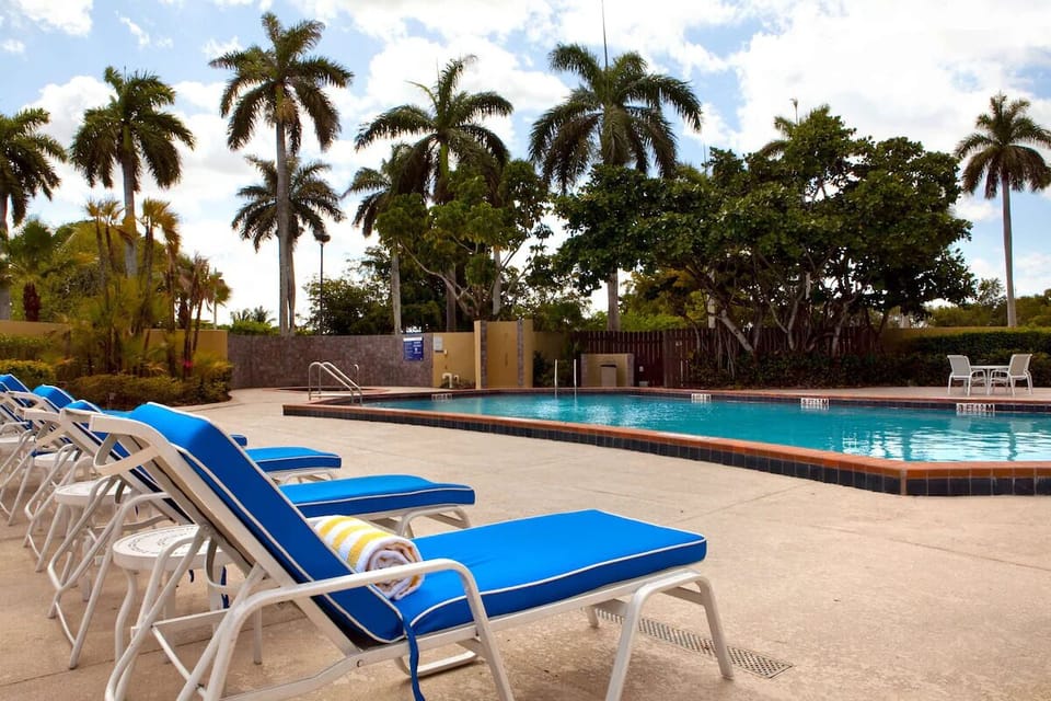 Lounge poolside under palms and soak up vacation calm.
