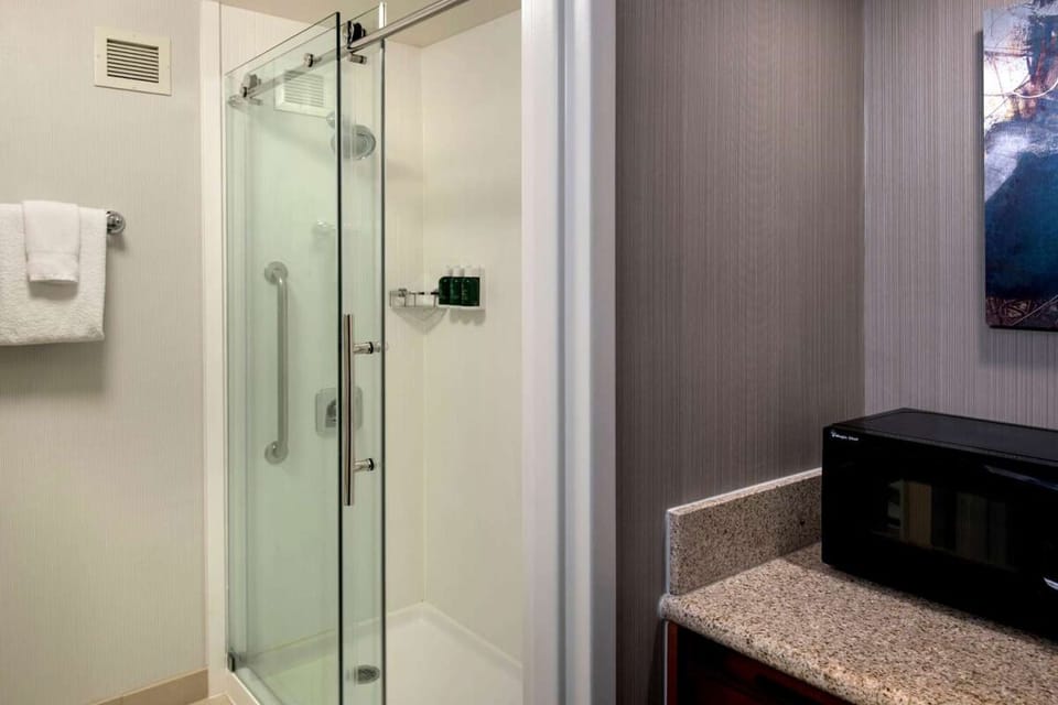 Refresh in a spotless walk-in shower with plush towels.