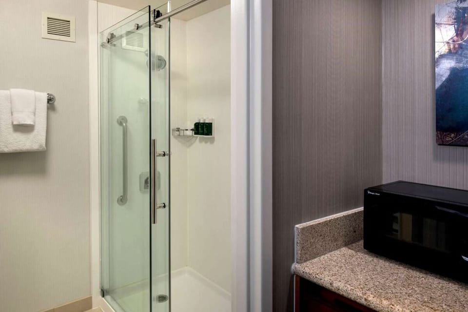 Refresh in a spotless walk-in shower with plush towels.