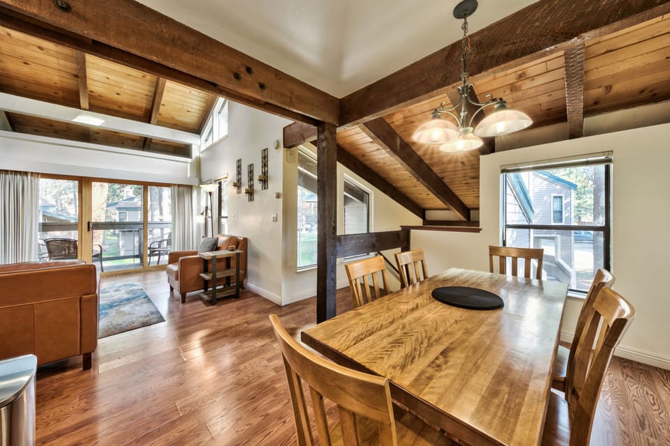 Relax in your rustic dining space with exposed beams and rich wood details creating a cozy mountain retreat atmosphere.