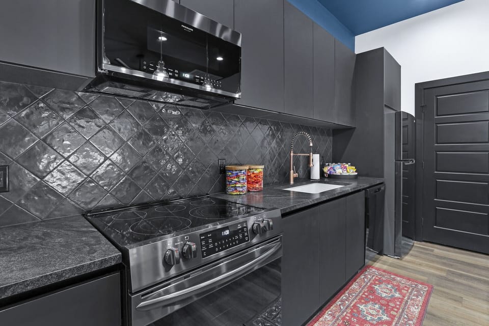 The kitchen is fully stocked with standard appliances