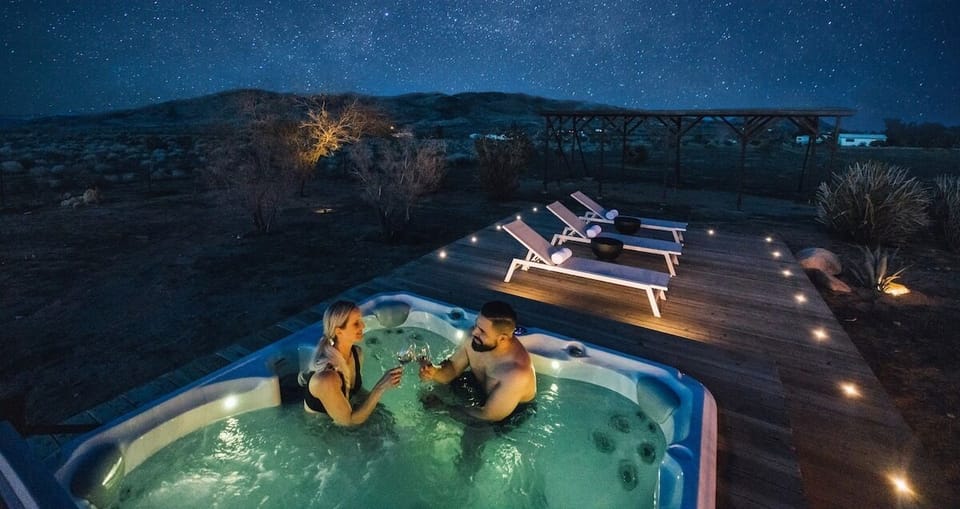 Sipping wine, soaking, and gazing at the starry night sky from your own hot tub