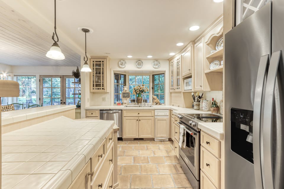 Kitchen with wide selection of cooking equipment, spices and baking basics