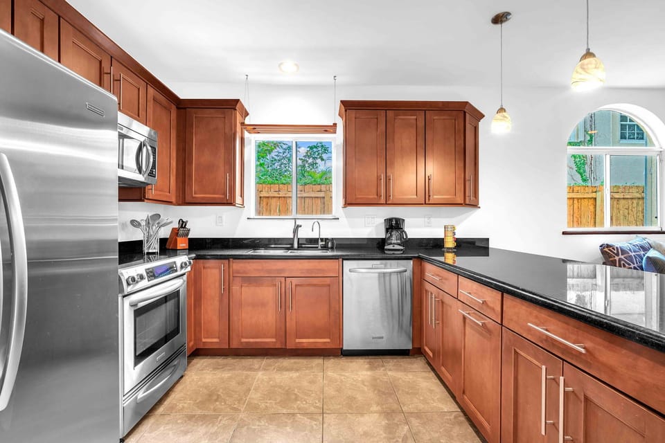 Spacious and fully equipped kitchen adorned with beautiful granite countertops, offering plenty of room for meal prepping.