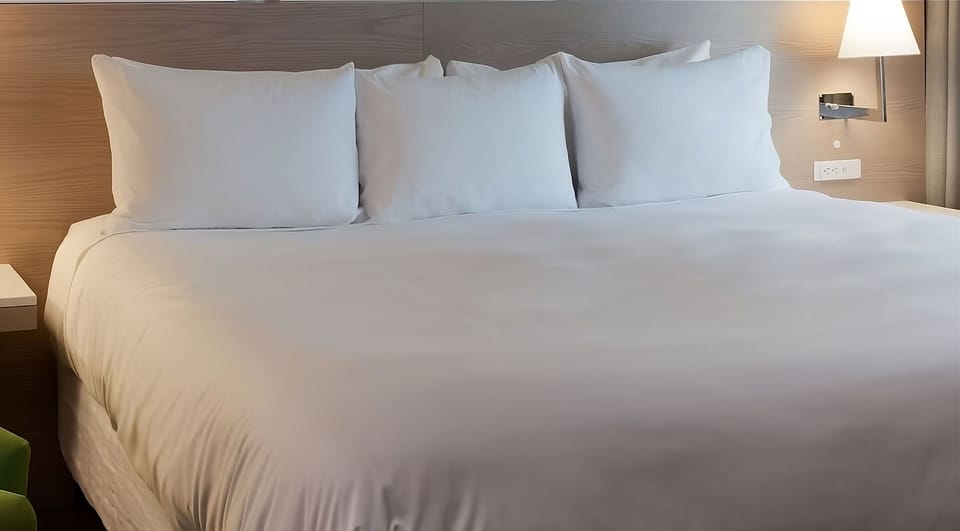 Drift off on crisp linens and plump pillows for deeper sleep.