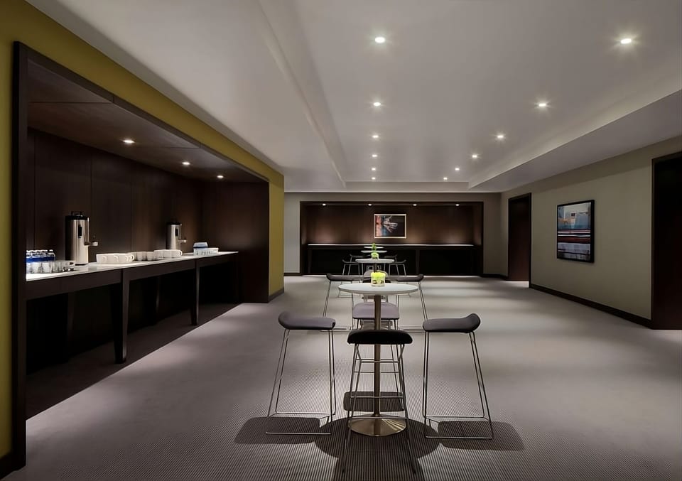 Sip coffee between sessions in a sleek, quiet lounge.