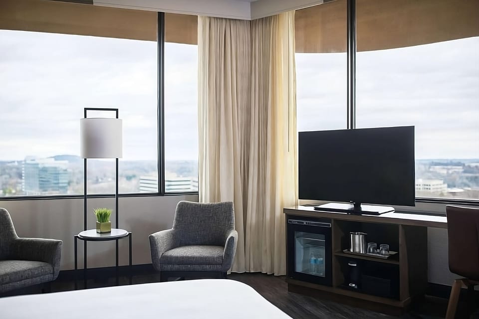 Sip coffee by corner windows in cozy lounge chairs.