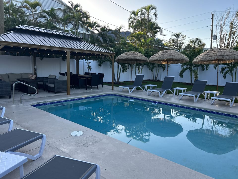 Private tropical oasis with heated pool and lit gazebo