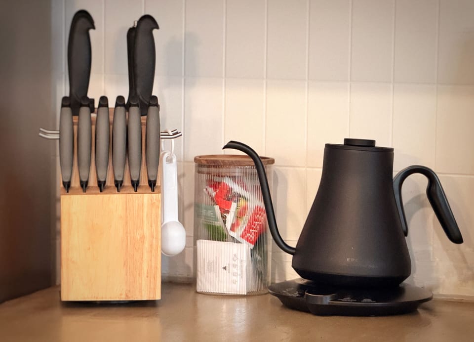 Modern kitchen setup with premium kettle, knife set, and thoughtful essentials